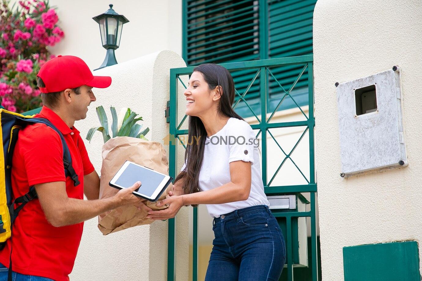 happy woman receiving food from grocery store taking package from courier her gate shipping delivery service concept 74855 11832