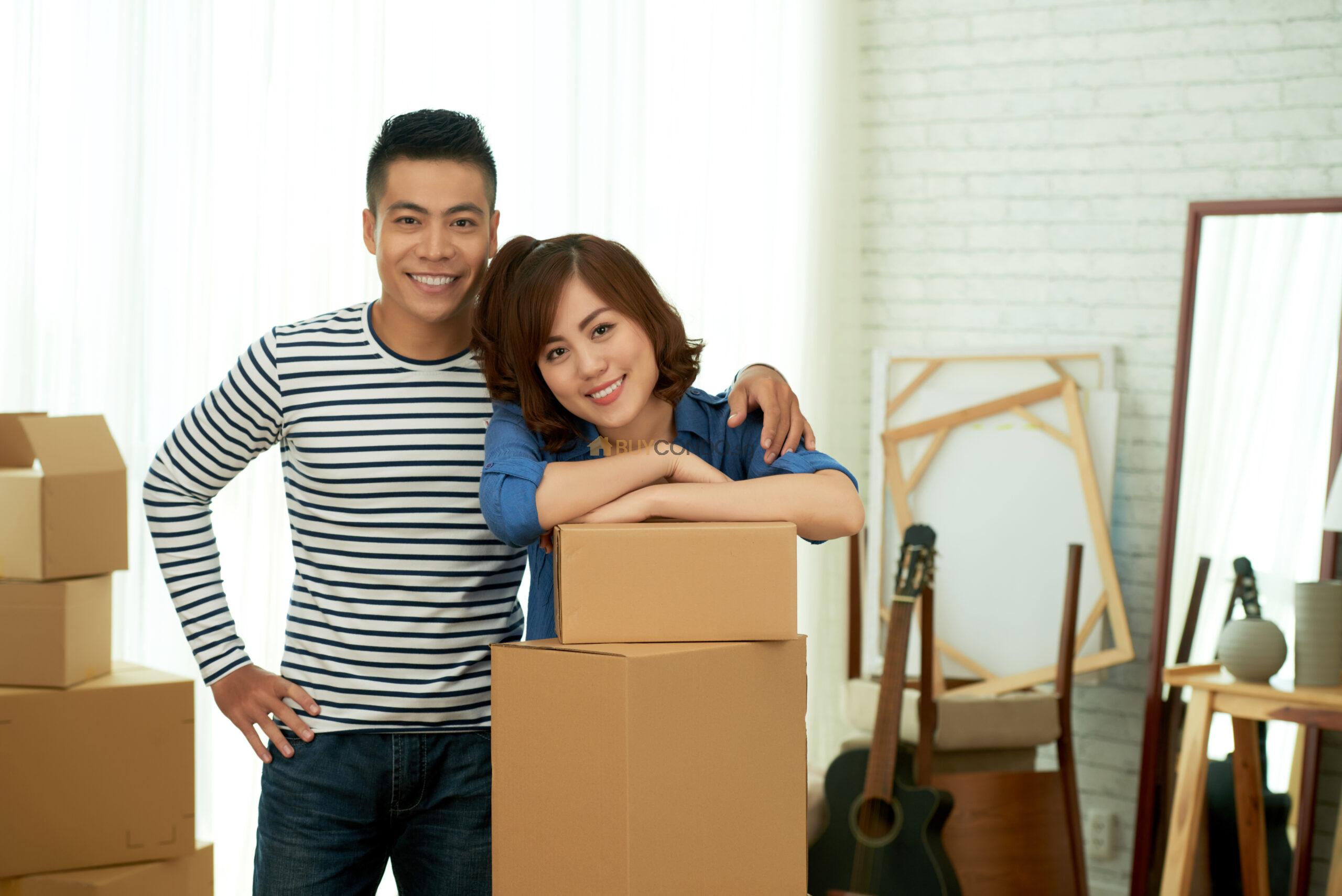 portrait happy couple posing package boxes before relocation new apartment scaled